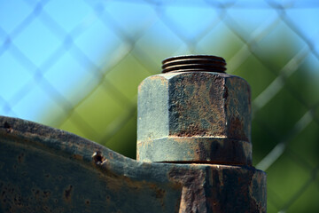 An oversized big screw of an old letterpress. 