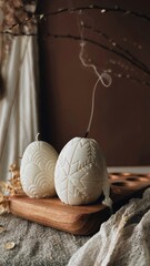 Traditional Easter decor.Burning soy candles in the shape of white eggs on a brown background