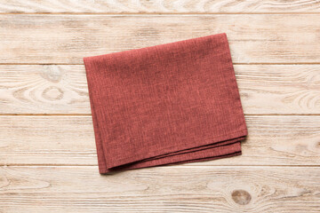 top view with red empty kitchen napkin isolated on table background. Folded cloth for mockup with copy space, Flat lay. Minimal style