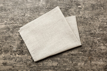 top view with gray kitchen napkin isolated on table background. Folded cloth for mockup with copy space, Flat lay. Minimal style