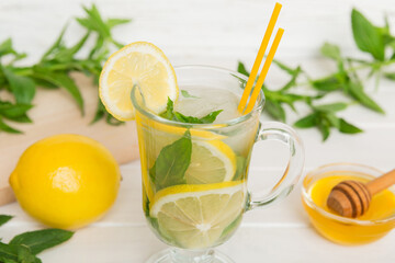 Mojito cocktail. Refreshing mojito cocktail with lime, lemon and mint in a tall glass with a stick