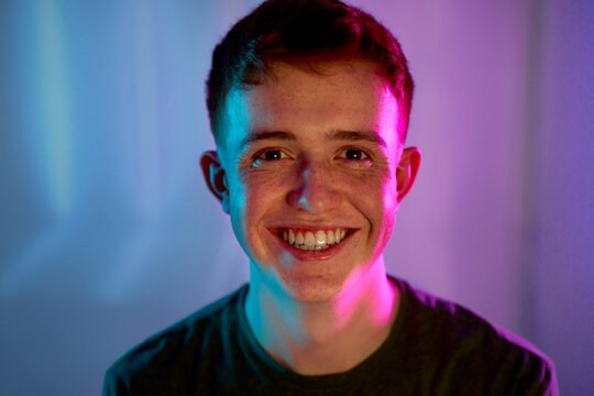 Cheerful young man with light on face