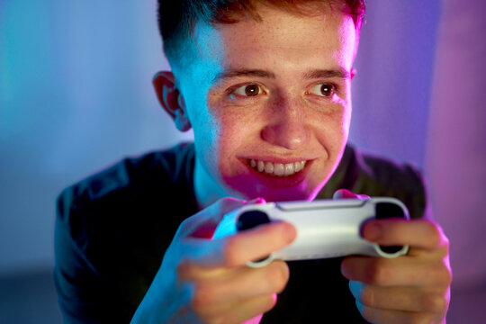 Happy young man playing video game