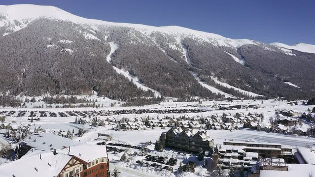 Aerial Sky chutes mountain village pan up drone Woodward Barn Copper Mountain Colorado mid winter fresh snow early morning cold