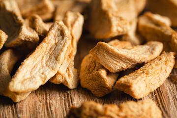 Homemade dried organic apple sliced on wood background.