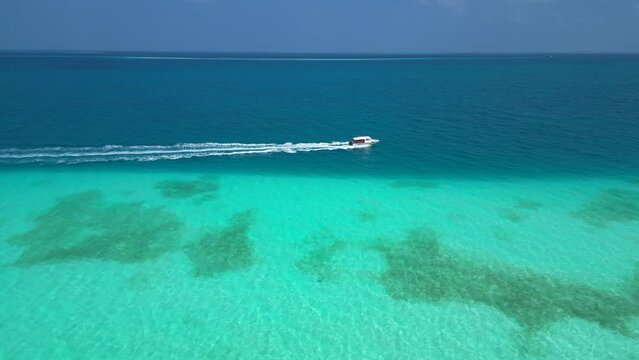 stunning blue ocean aeral view tourist yacht plows the ocean fun and vacation on Maldives