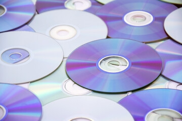 Lots of old CDs are laid out as a background.