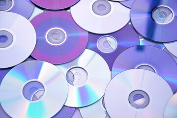 Lots of old CDs are laid out as a background.