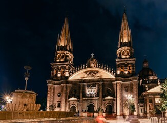 Fototapeta na wymiar Mesmerizing skyline of Guadalajara Cathedral in Mexico captured under light against the night sky
