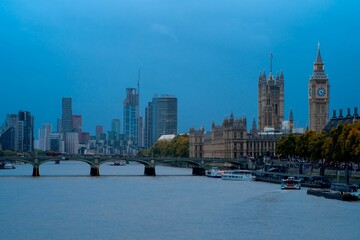 Palace of Westminster and Big Ben with the skyline of London city at sunset