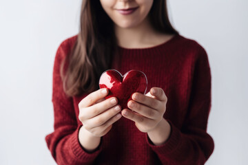 Love and Affection. Woman holding a heart-shaped gift isolated on white background with space for text. Copy space. Gift giving concept AI Generative