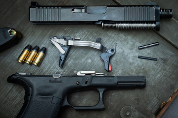 Pistol cleaning and repair, disassembled weapons.