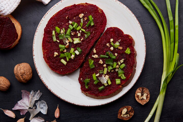 Beetroot spread with spring young onion and walnuts sandwiches. Healthy vegan food. Top view