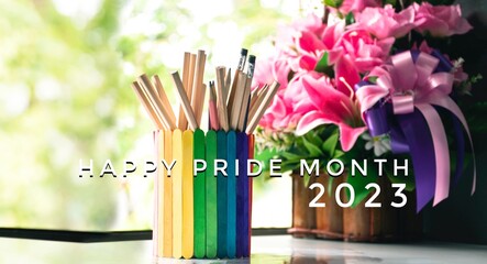 happy pride month 2023 on rainbow case which has various pencils inside background, concept for LGBT celebration in pride month and home decoration of LGBT people around the world.