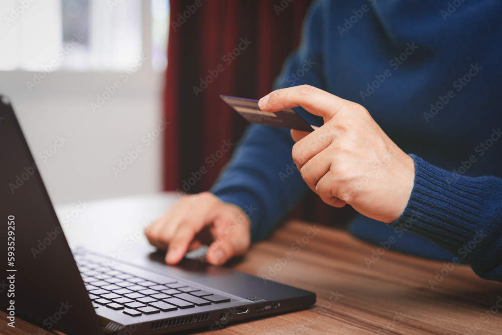 Poster young man using laptop to register via credit card to shop online. credit card secure online shoppin