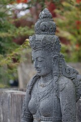 Fototapeta na wymiar Vertical closeup shot of an Indian Goddess statue found in a garden