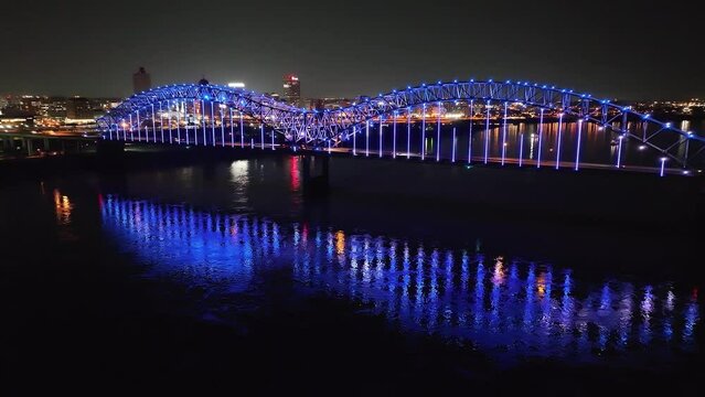 Hernado De Soto bridge in Memphis, Tennessee with illuminated Mighty Lights at night with drone video moving forward low.