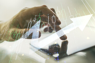 Multi exposure of abstract financial diagram with upward arrow and hand working with a digital...
