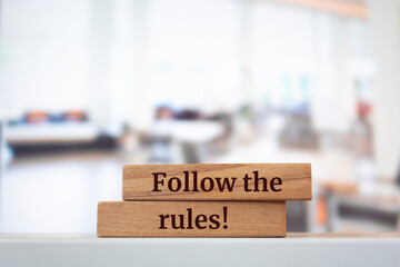 Wooden blocks with words 'Follow the rules'.