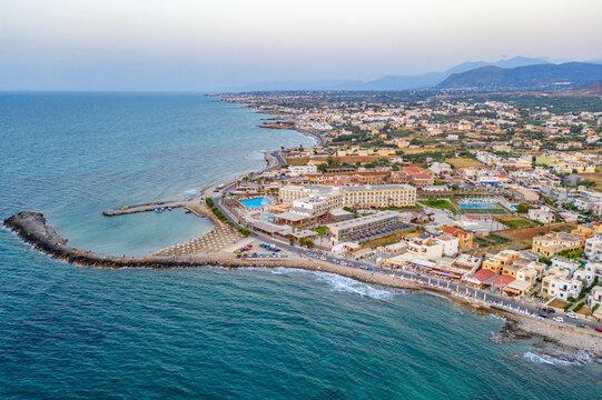 Marina Port Gouves - late afternno drone aerial photo, city landscape, buildings and blue water anb sandy beach