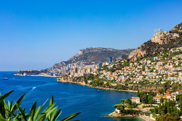 Fototapeta na wymiar High angle view of Monaco, Monte Carlo, from Roquebrune, France. Panoramic view. Summer time, 2022.