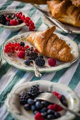 Closeup of croissant with berries on plate