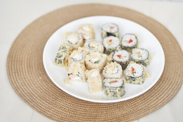 Delicious rolls with tofu and vegetables. Japanese rolls are on a plate. Japanese cuisine in the restaurant is prepared from exquisite ingredients. High quality photo