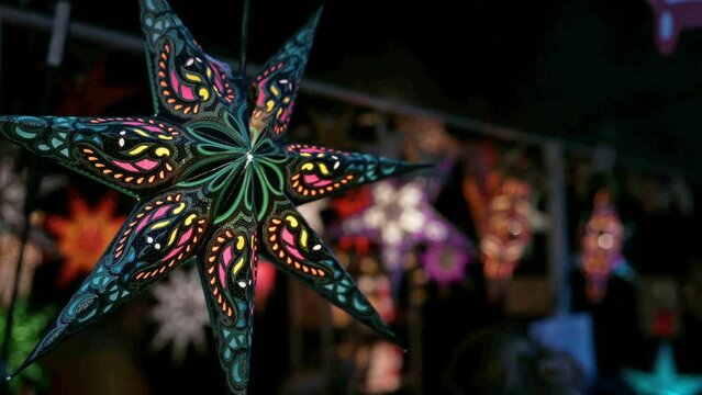 Decorative lighting on a market. Colourful star lights at night.