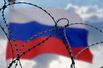 Barbed wire on background of flag of Russia. Sanctions against Russia.
