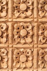Texture of stone wall with carved floral elements