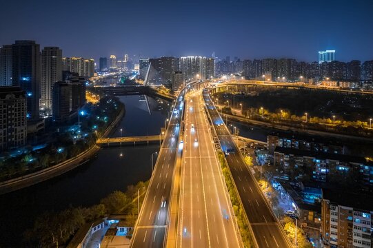 Aerial view of the road with the city in the background at night, in Tianjin, China