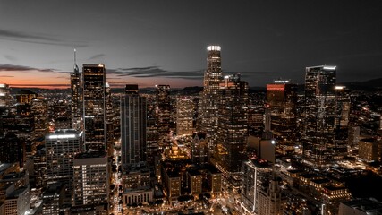 Aerial view of cityscape Los Angeles surrounded by buildings during sunset