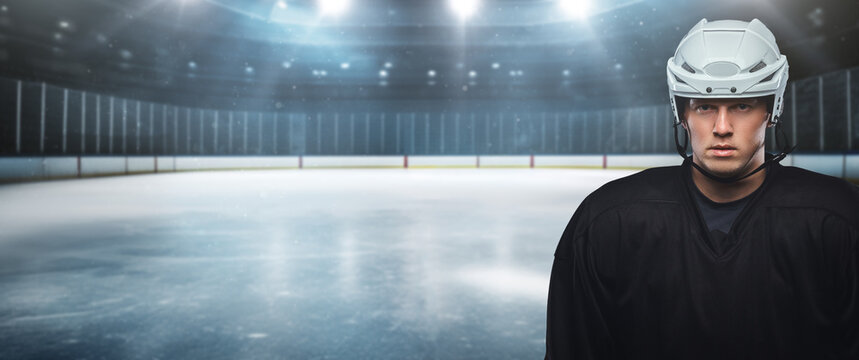 Shot of professional hockey player dressed in black uniform in stadium.