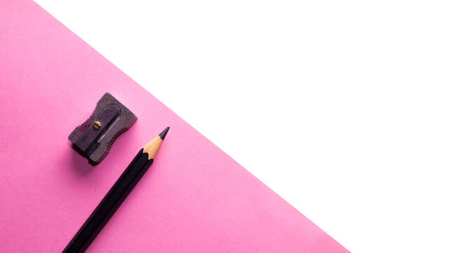 PNG image, pencil sharpener and black pencil on pink paper sheet isolated png
