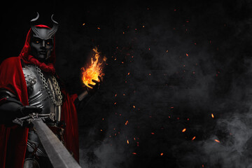 Portrait of evil sorcerer with fireball dressed in red robe and horned mask.