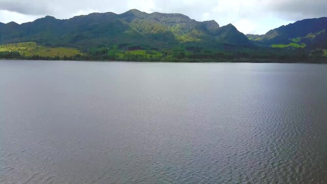 Mountains on a lake shore, aerial reveal of Embalse del Neusa, Colombia