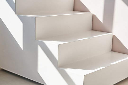 Stairs podium, stairs platform. Podium with stairs . Studio room background with sunlight and shadows for product demonstration. The shadow of geometry form. High quality photo