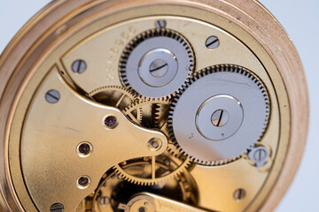 gold pocket watch close-up, clock mechanism from the inside.