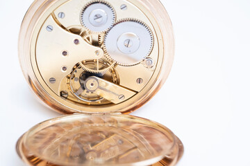 gold pocket watch close-up, clock mechanism from the inside.