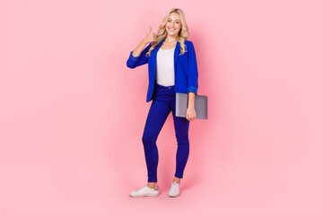 Photo of pretty business lady hold modern technology netbook thumb finger up smart casual outfit isolated pink color background