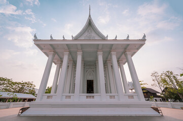 Chonburi, March 12, 2023. Wat Phon Prapa Nimit, This striking white Buddhist temple in a tranquil setting features a silver and mirrored interior.