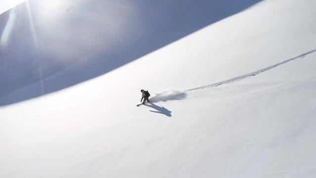 FPV aerial drone follow cam of male snowboarder spin butter dream powder open fresh snow run epic Vail Pass Colorado