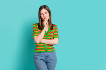 Photo of minded smart lady wear stylish clothes arm touch face look empty space interesting offer isolated on cyan color background