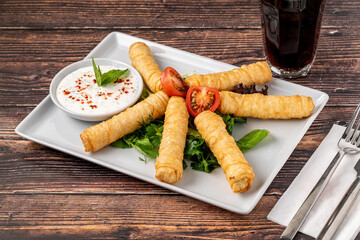 Turkish Cigar Shaped Rolls on a white porcelain plate. The Turkish name is Sigara Boregi
