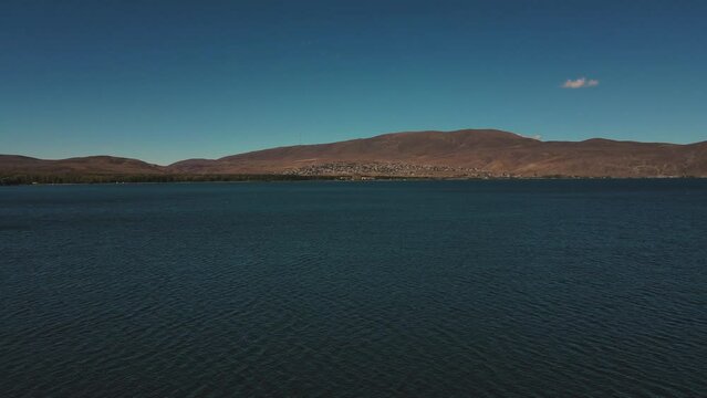 Aerial view of lake Sevan with seagulls flying over the water, Gegharkunik province, Armenia