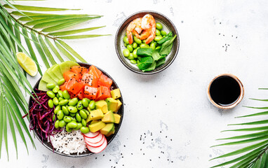 Poke bowl with salted salmon, avocado, radish, edamame beans, cabbage and white rice. Soy sauce, lime and sesame dressing. White table background, top view