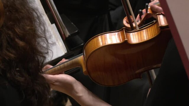 close up on violist and violin and the notes while playing