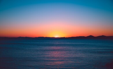 Drone shot of scenic sunset over the calm sea in the evening, cool for the background