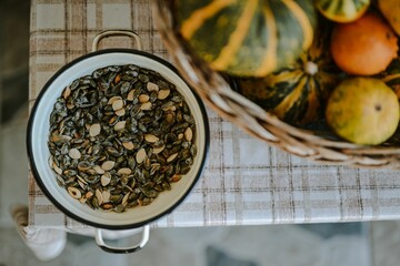 Closeup top view of seeds of and pumpkins in pots on an isolated background