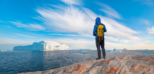 A scientist researches the melting of glaciers - Tiniteqilaaq, Semilik fjord - East Greenland